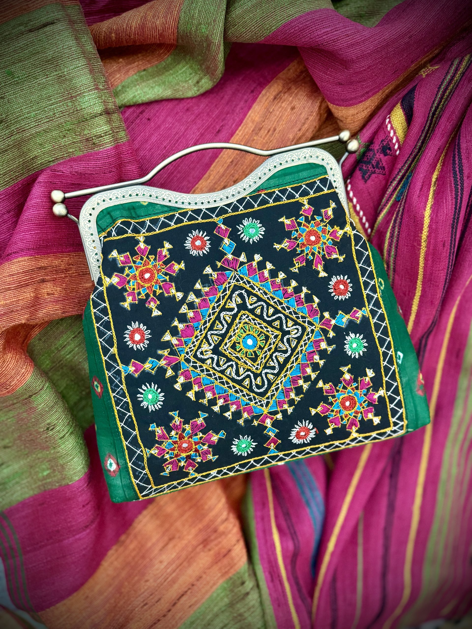 Green Bandhani handbag with colorful Kutchi embroidery and antique metal frame