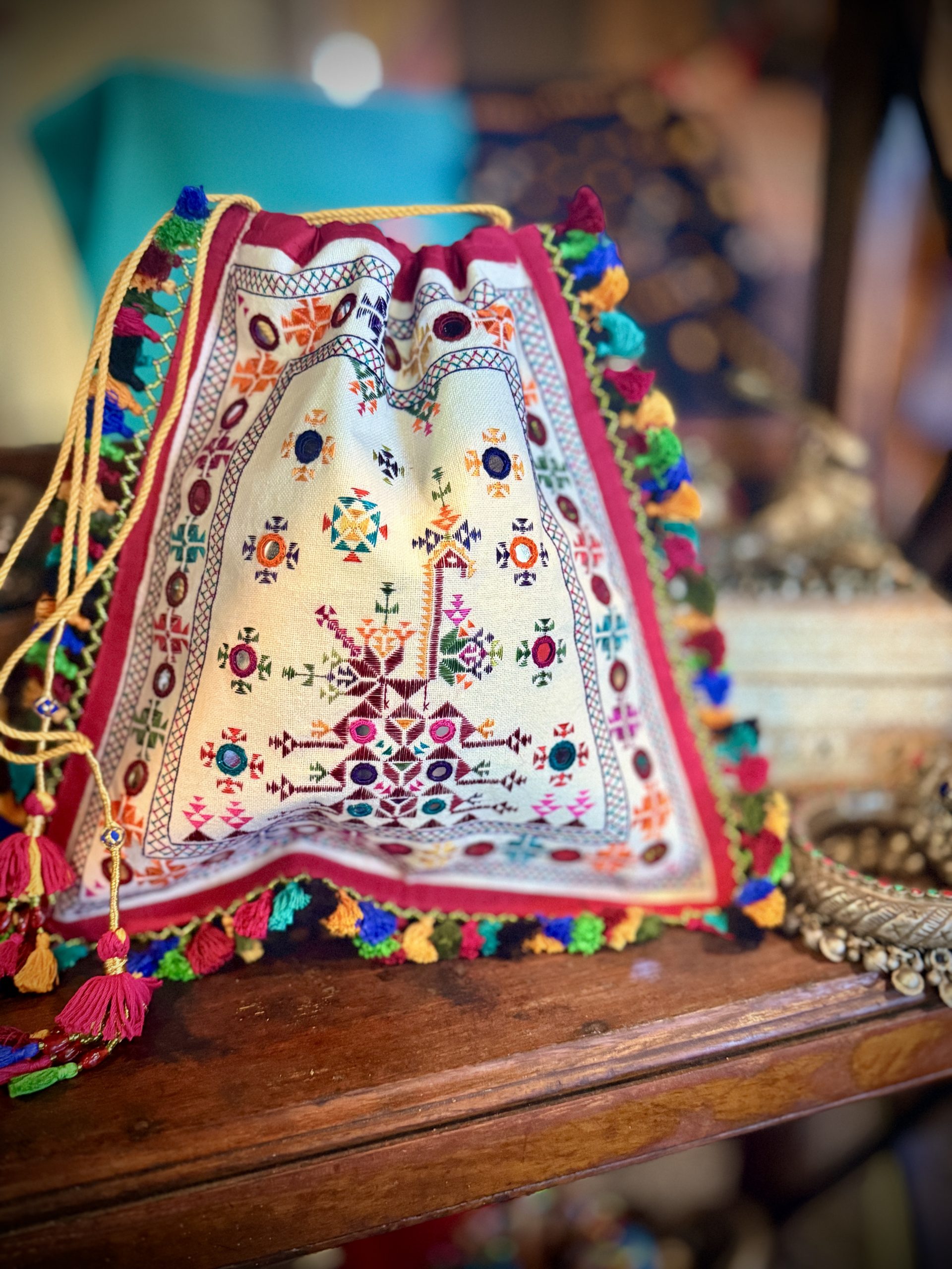 Signature hand-embroidered potli with genuine Abhla mirror work