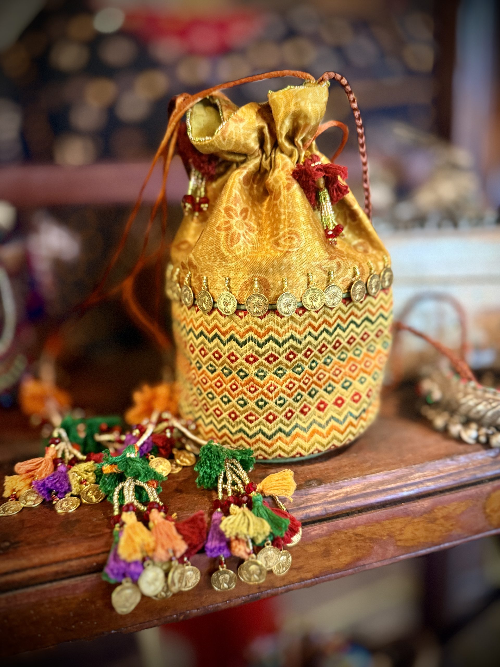 Gold Mashru silk potli with hand embroidery, coin details and tassels