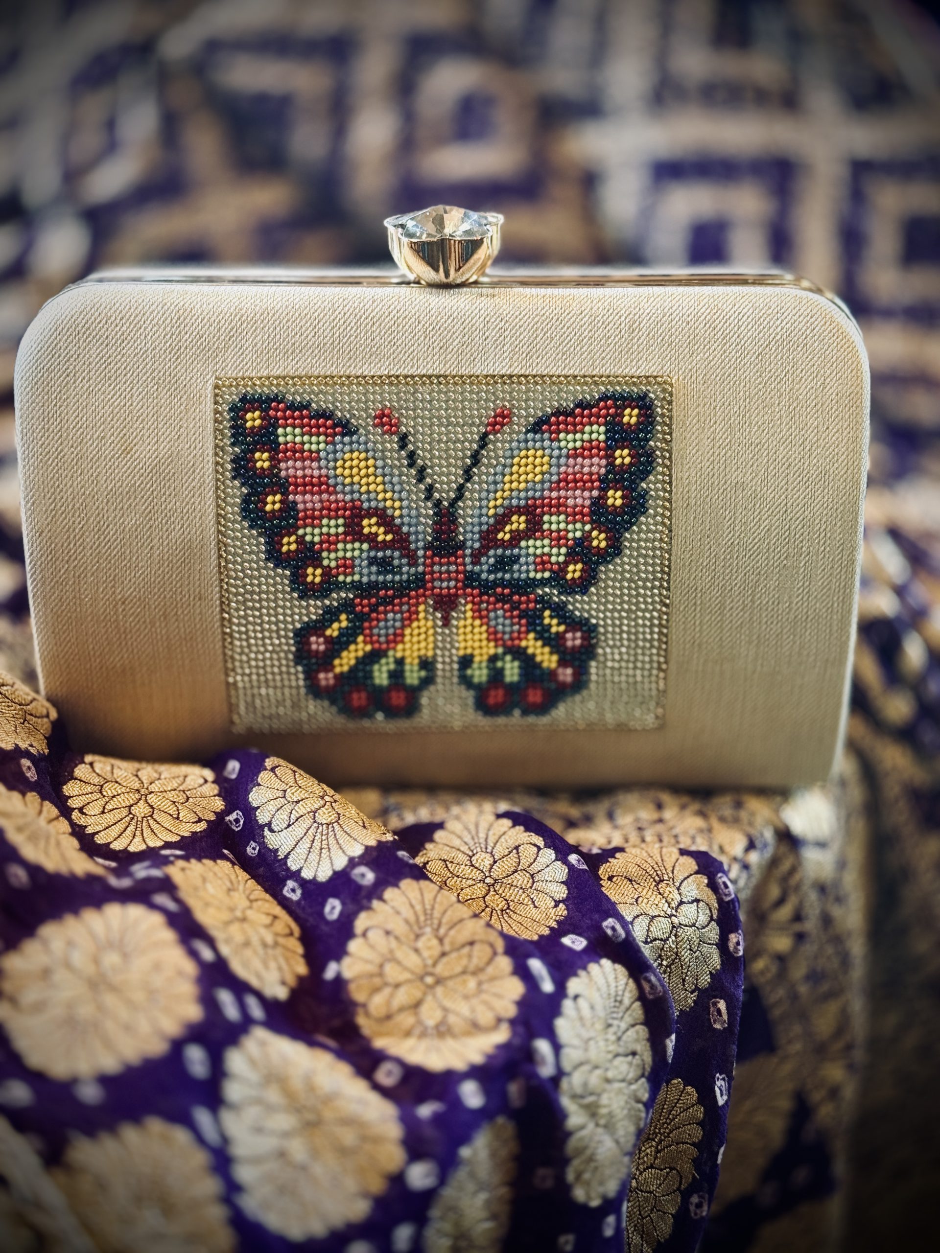 Ivory silk-brocade clutch with handworked Moti butterfly