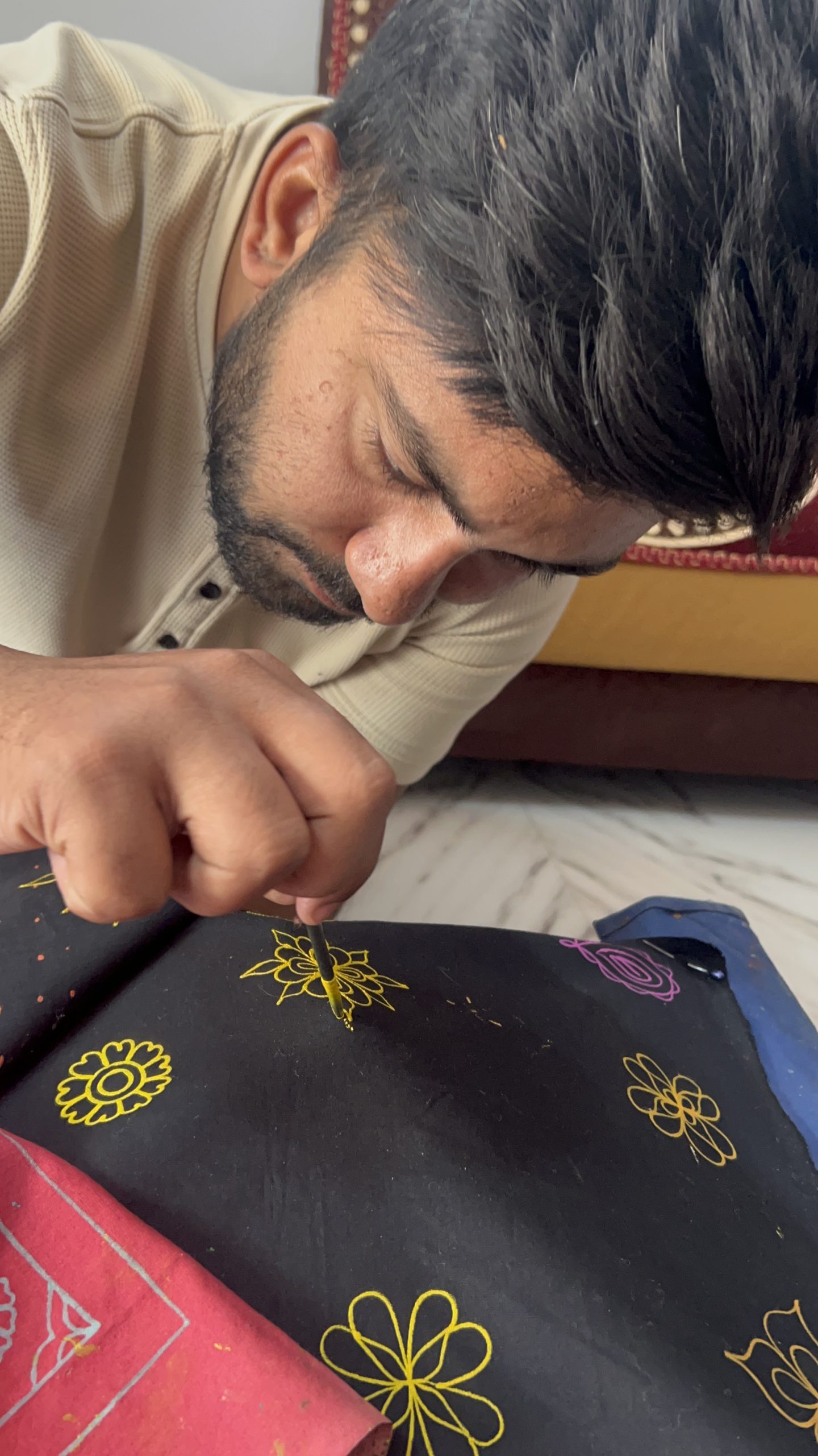 An artisan embroidering by hand