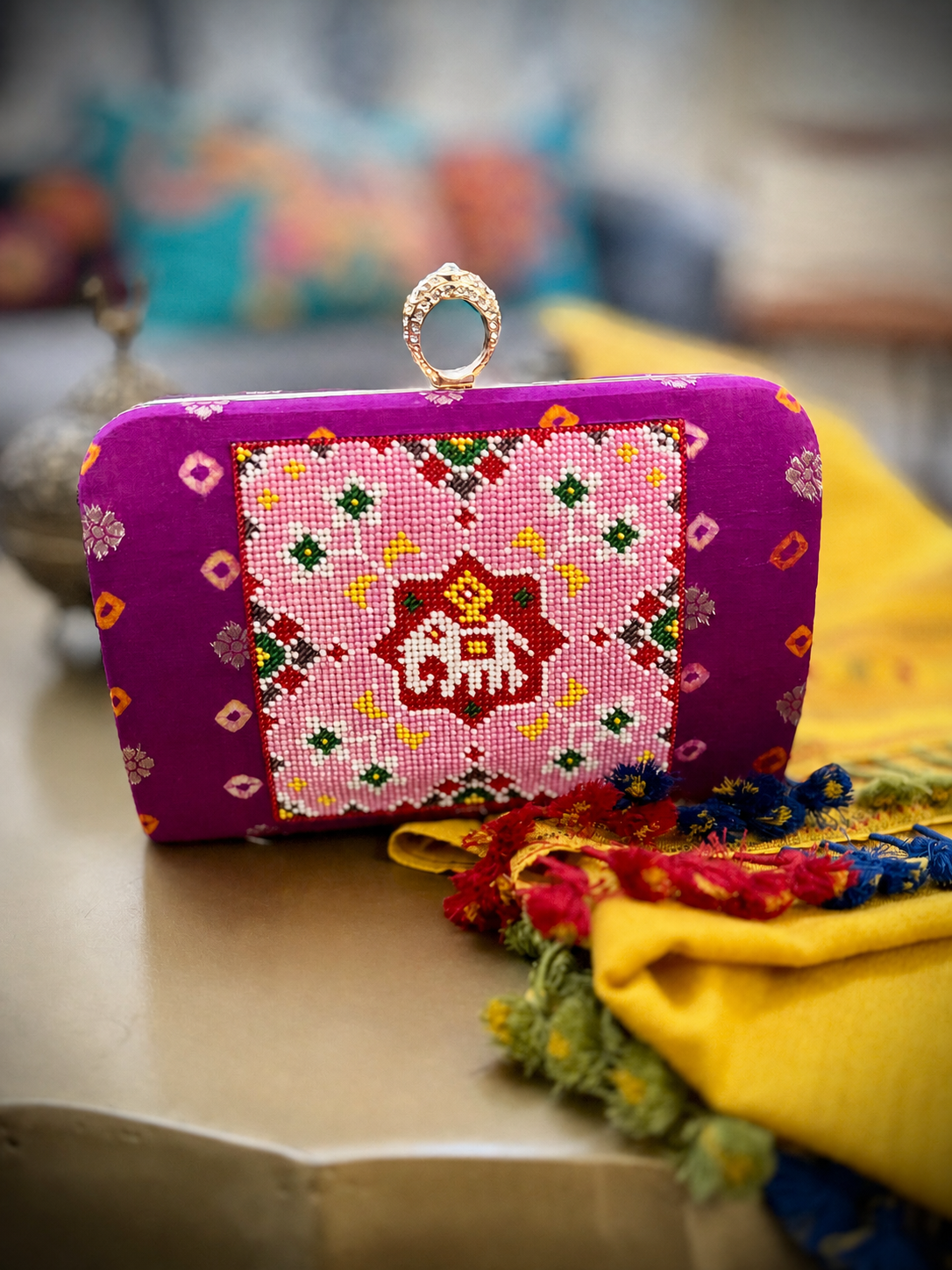 Magenta Bandhani clutch with pink Patola-inspired Moti work